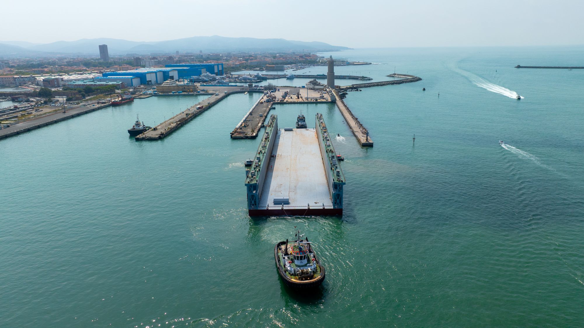 An aerial view of Lubsen's refurbished floating dock being manouevred by a tugboat