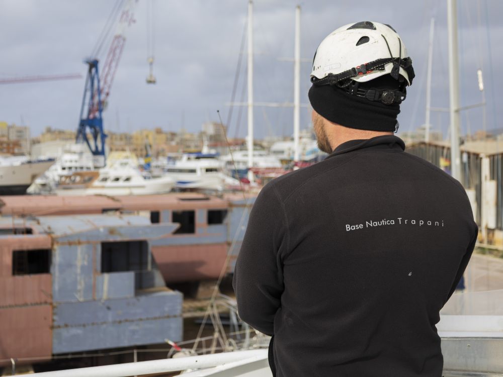 A shipyard worker watches over vessels being rebuilt