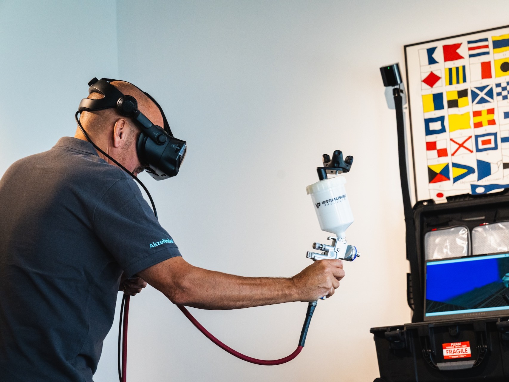 A man uses virtual reality technology to practice spray painting