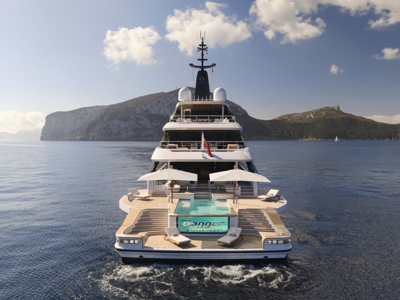 A view of a luxury superyacht from the aft, its engines beginning to power up