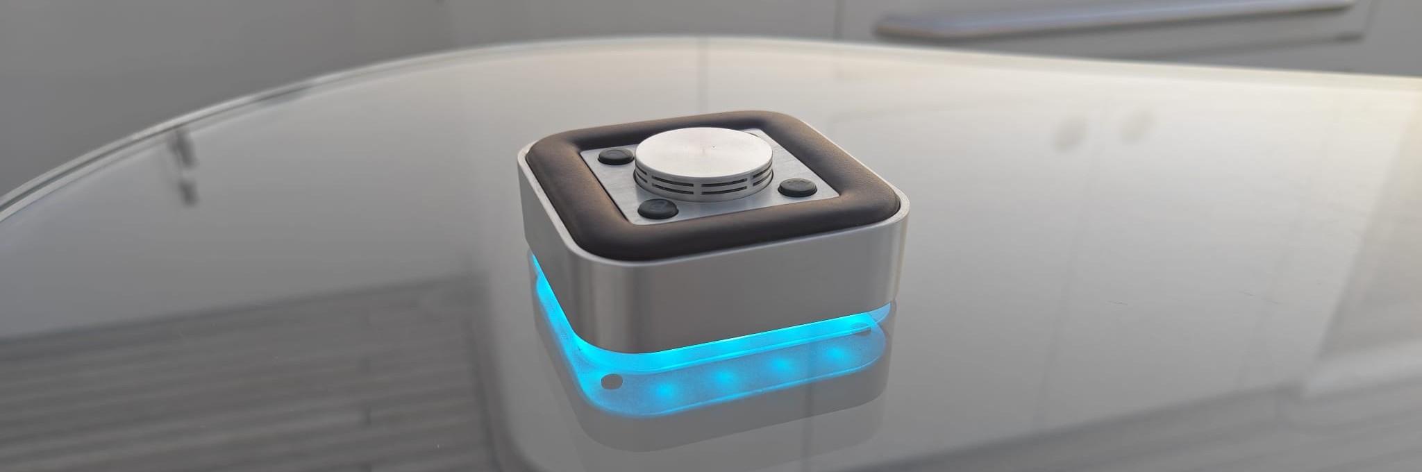 A small, futuristic box with a button on top for calling for assistance