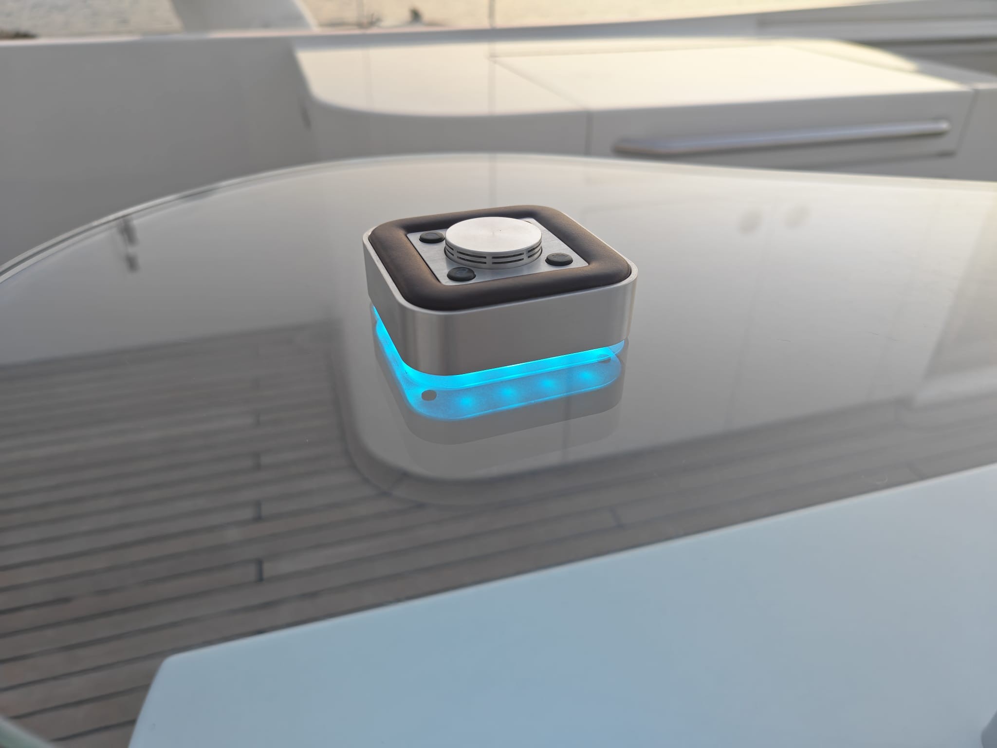 A small, futuristic box with a button on top for calling for assistance